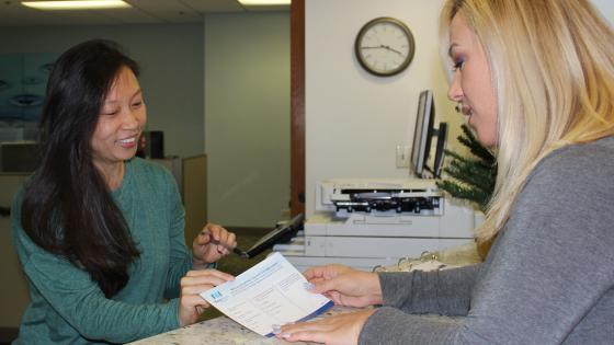 women exchanging survey card